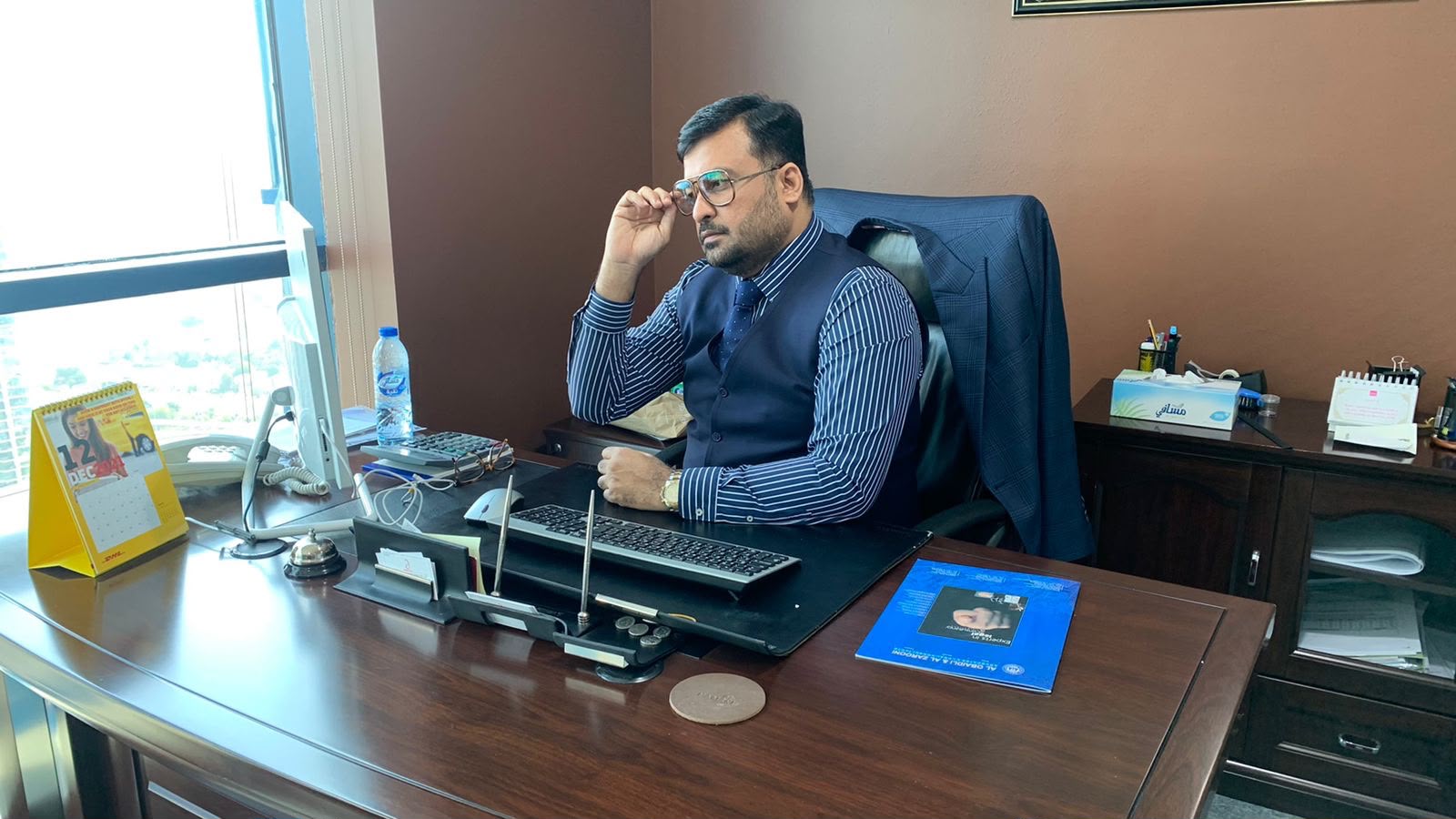 Shadab Shaikh at his desk, DMCC office